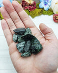 tumbled seraphinite stones in hand