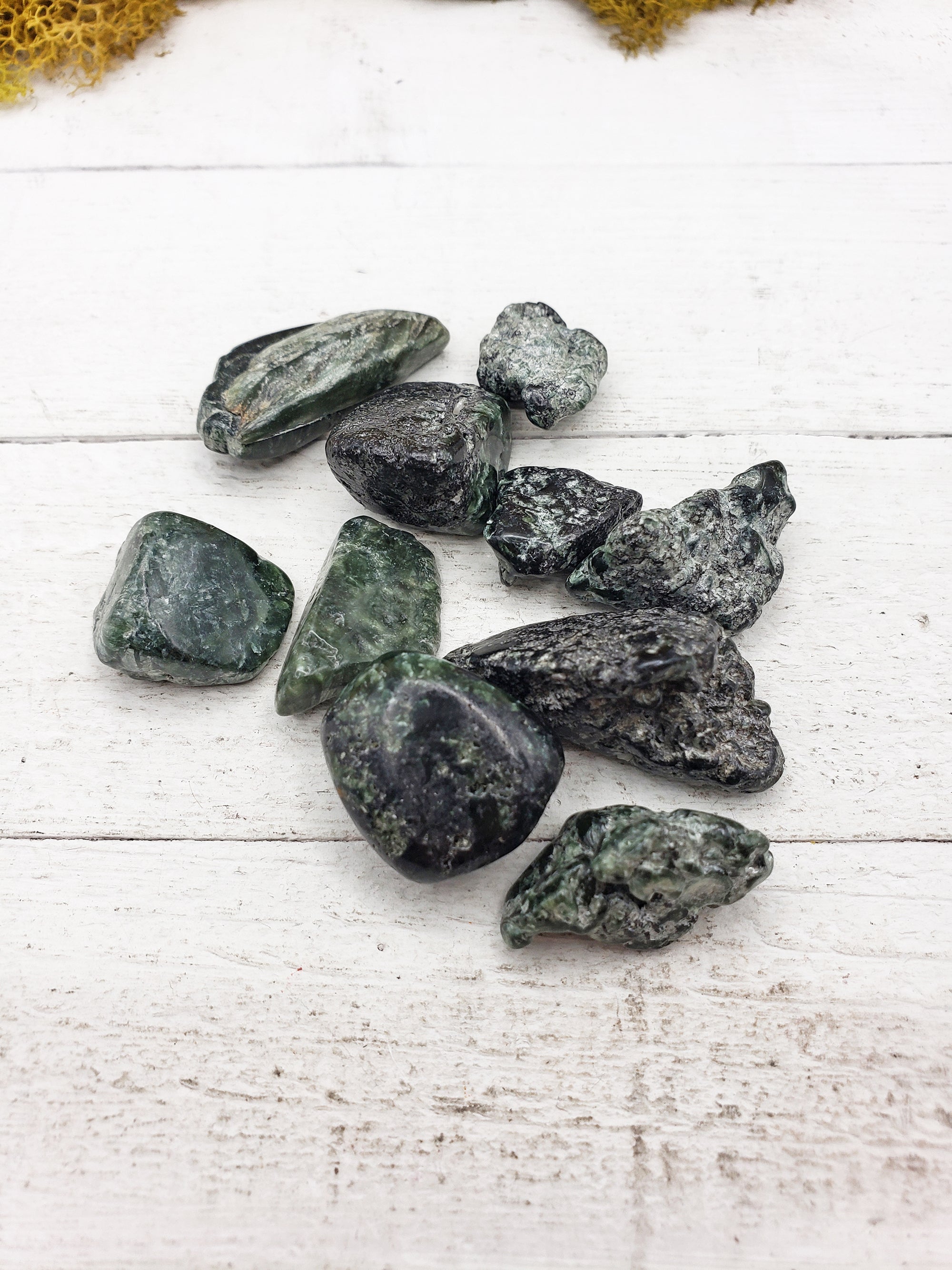 tumbled seraphinite stones on board