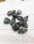 tumbled seraphinite stones on board