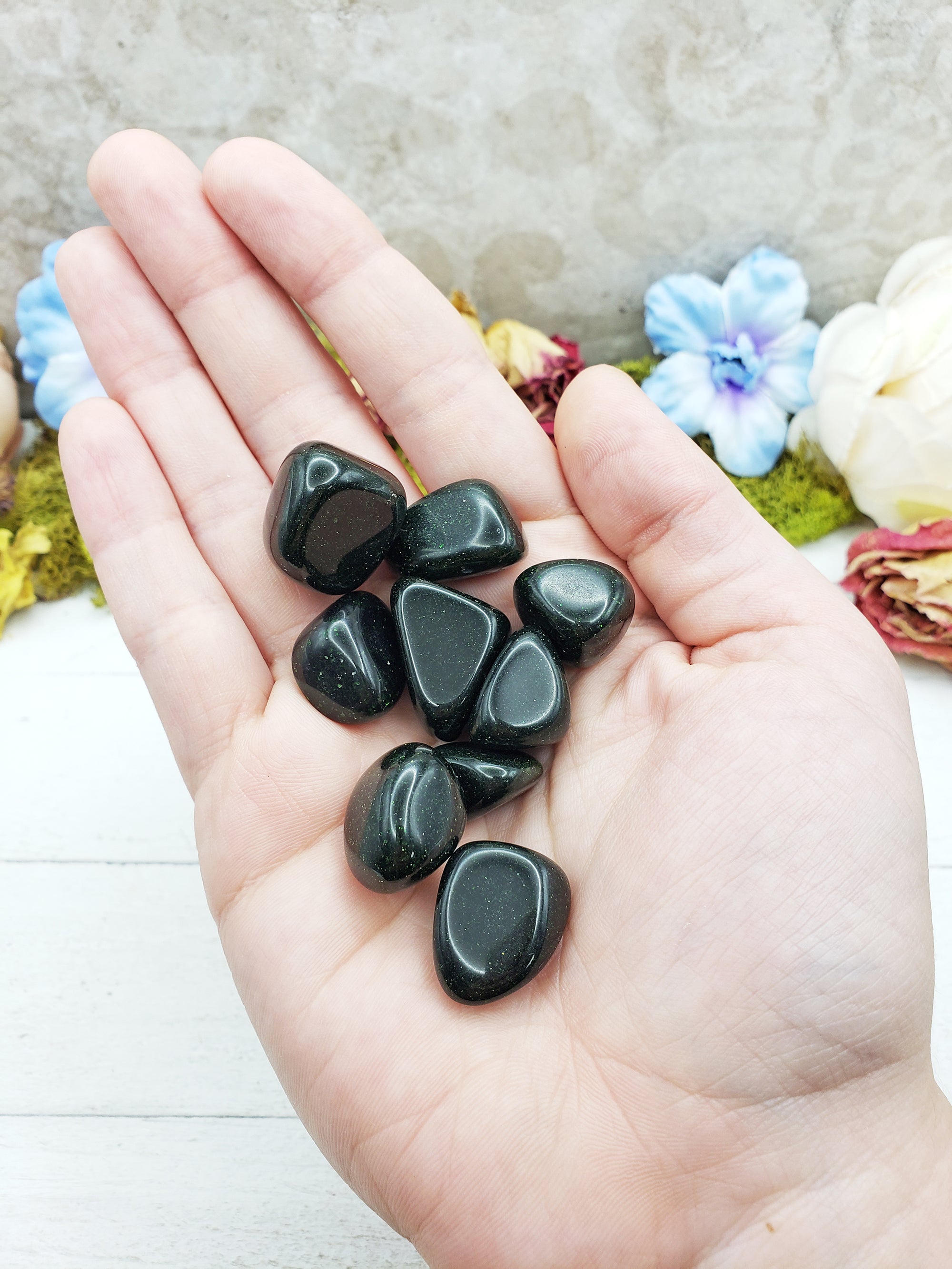 green goldstone crystals in hand