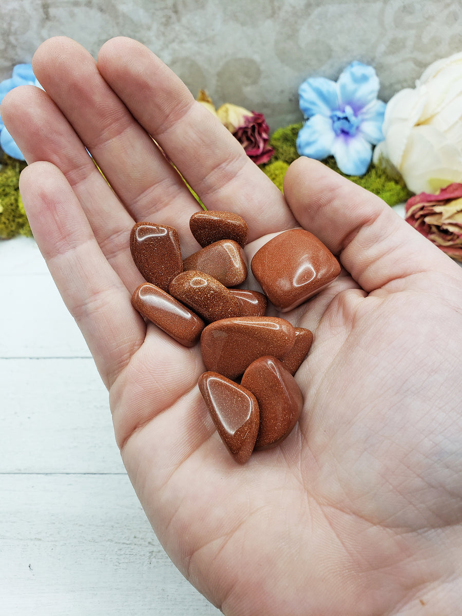 red goldstone crystals in hand