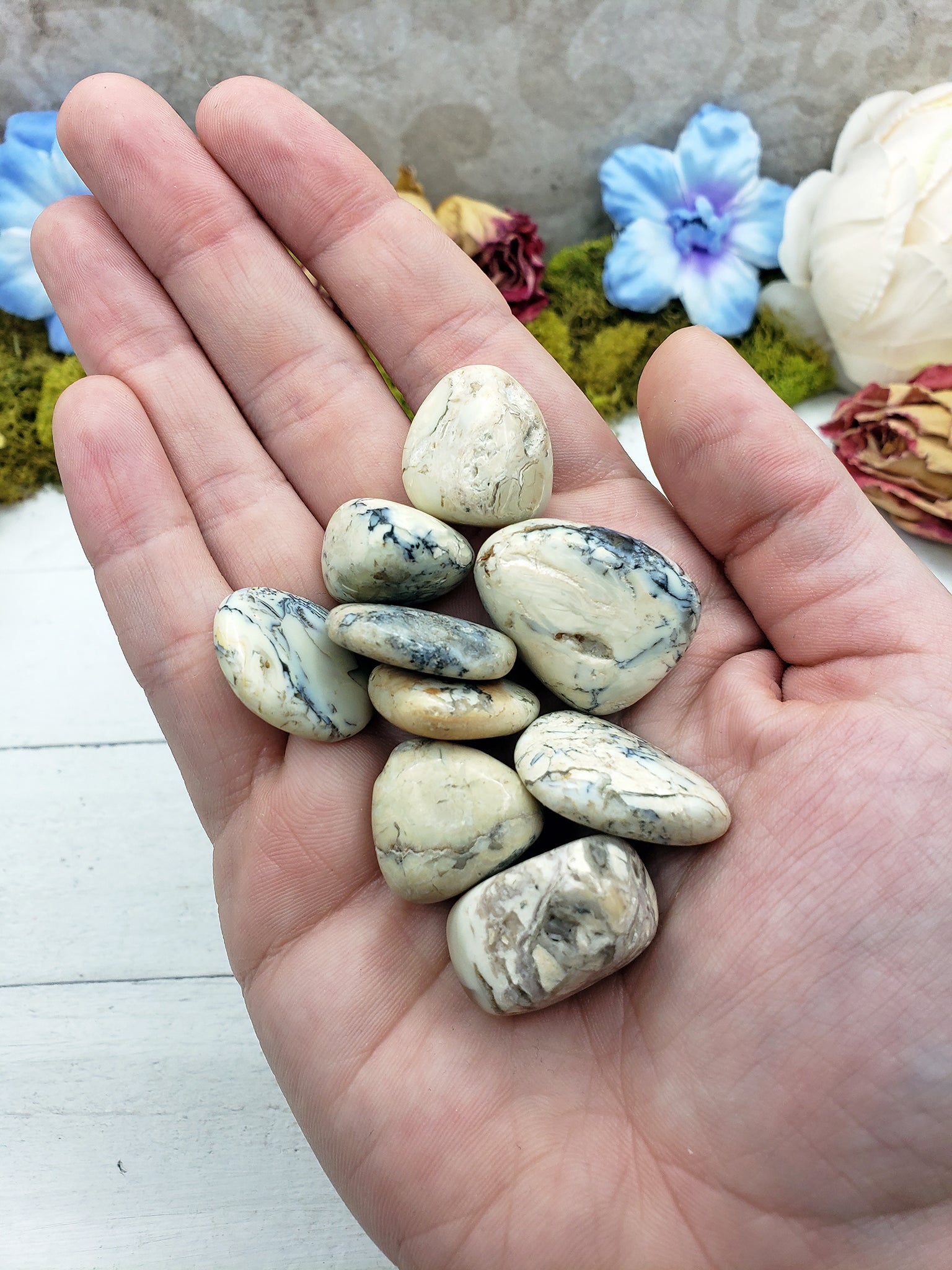 hand holding white opal stones