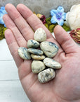 hand holding white opal stones