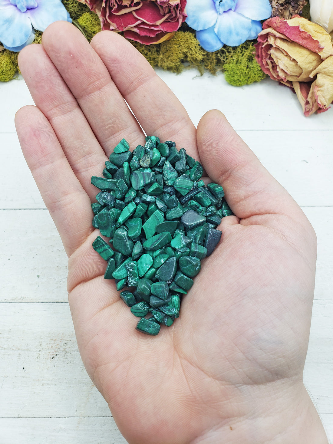 malachite crystal chips in hand