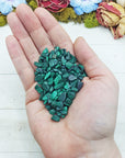 malachite crystal chips in hand