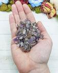 cacoxenite crystal chips in hand