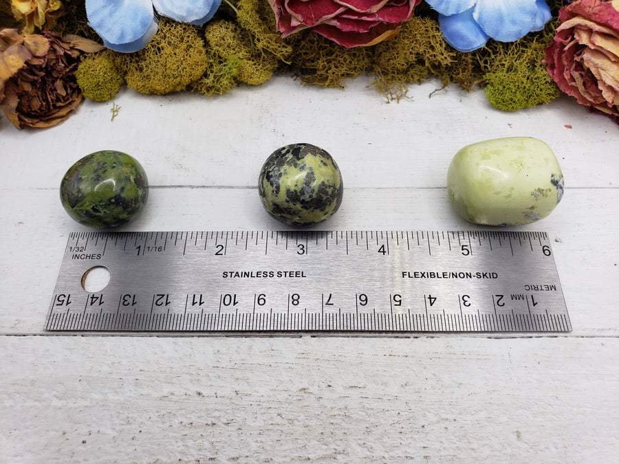 green serpentine stones by ruler