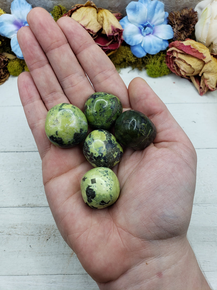 green serpentine stones in hand
