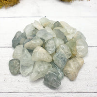tumbled aquamarine stone pieces on display