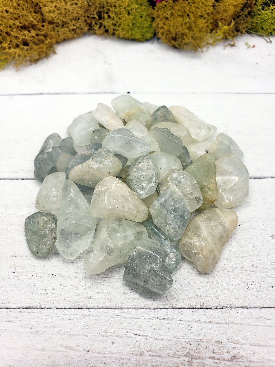 tumbled aquamarine stone pieces on display
