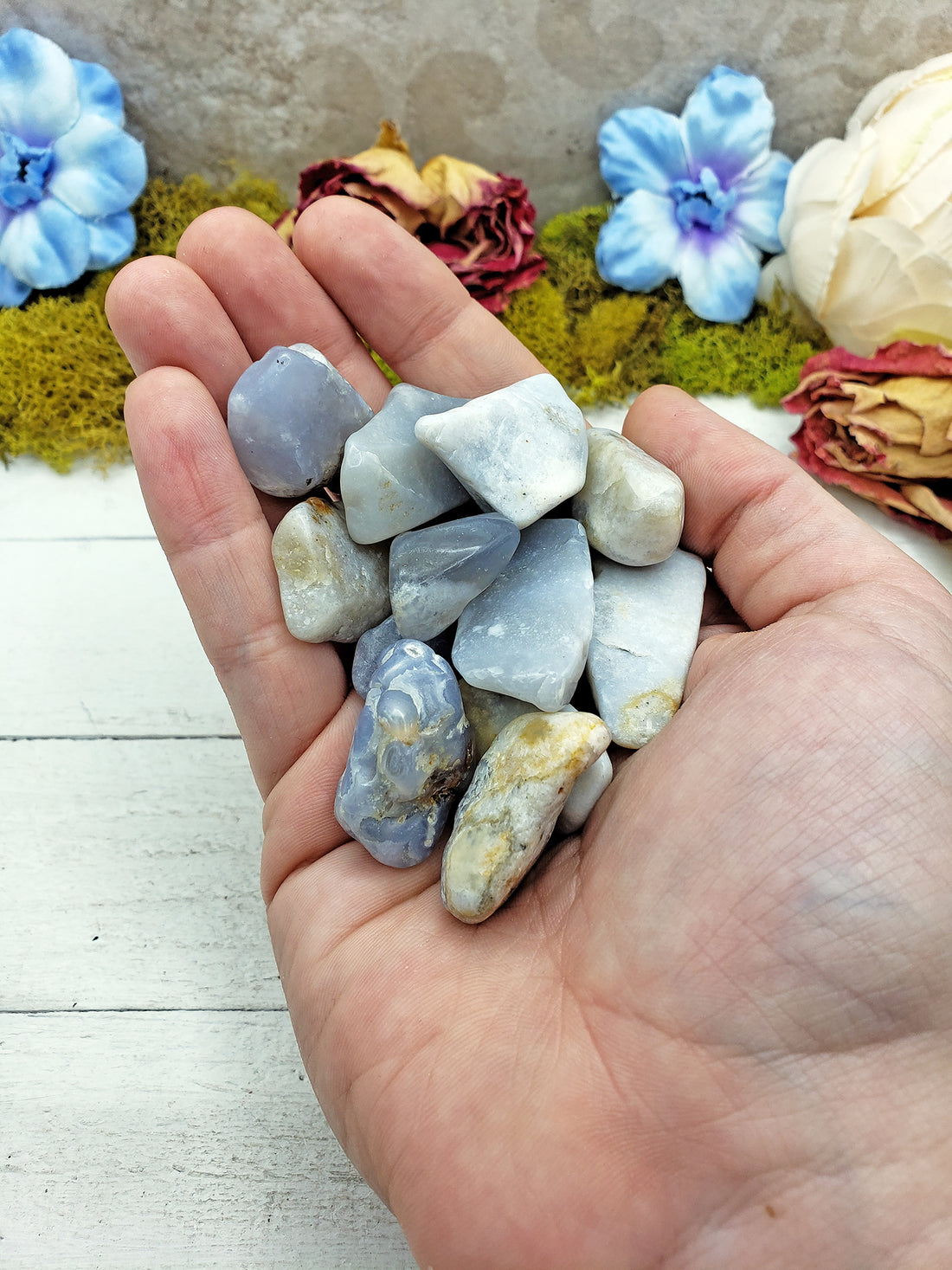 tumbled fancy blue chalcedony in hand