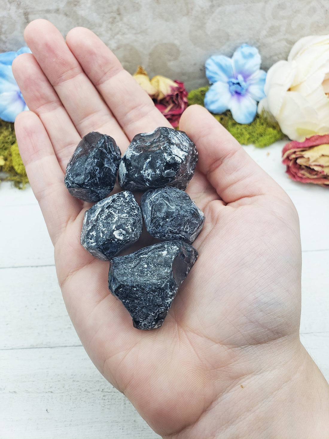 apache tear stones in hand