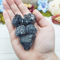 apache tear stones in hand