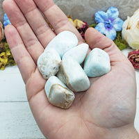 blue ocean caribbean calcite stones in hand
