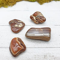 chocolate rhodocrosite stones on board