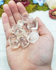 Clear obsidian stones in hand
