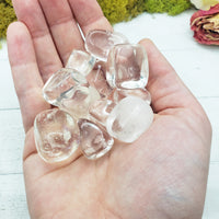Clear obsidian stones in hand