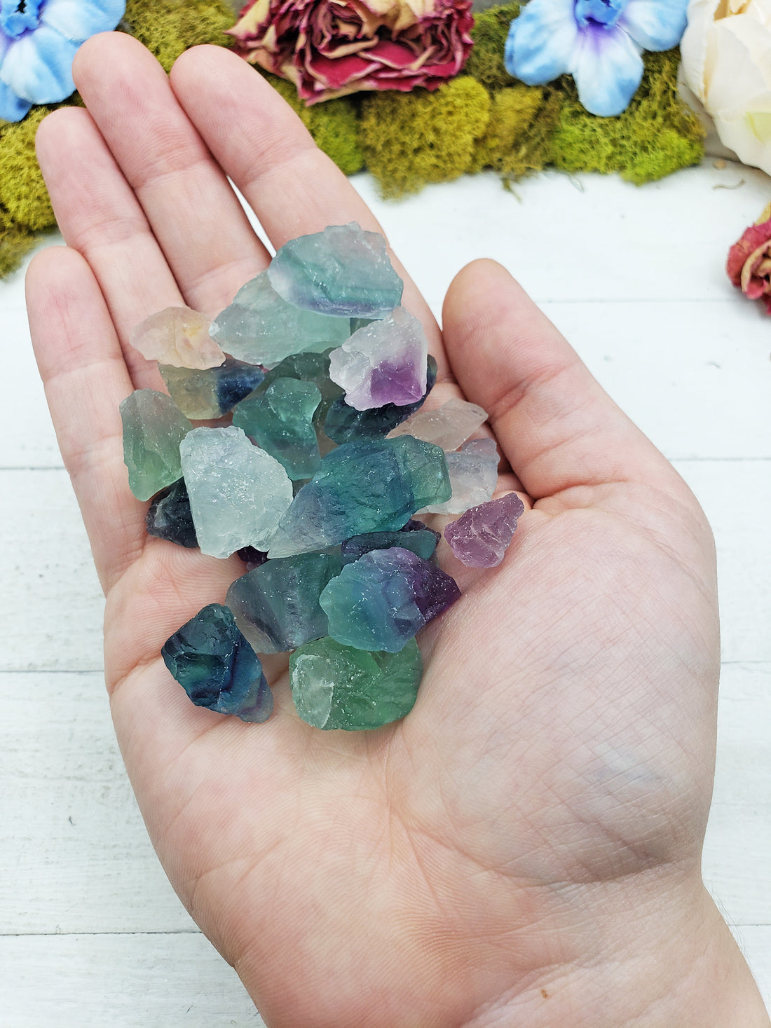 rough fluorite stones in hand