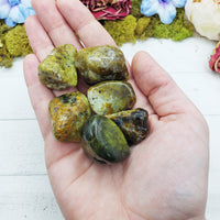 green opal stones in hand