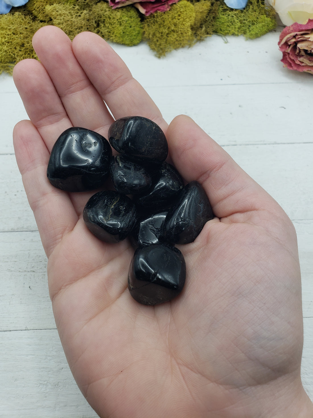 black tourmaline crystals in hand