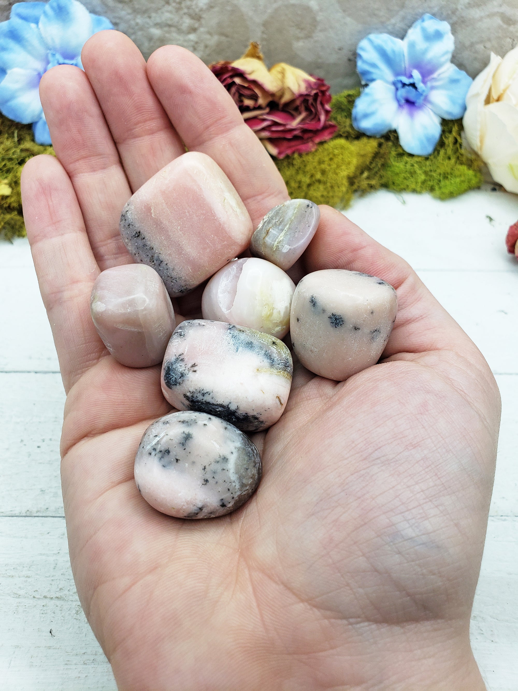 Pink Opal stones in hand