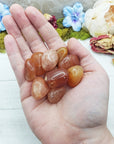 red aventurine crystals in hand