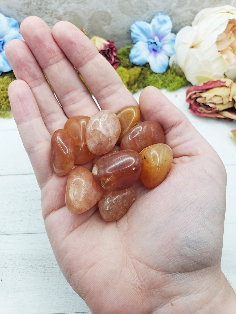 red aventurine crystals in hand