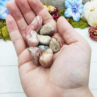 rhodocrosite crystals in hand