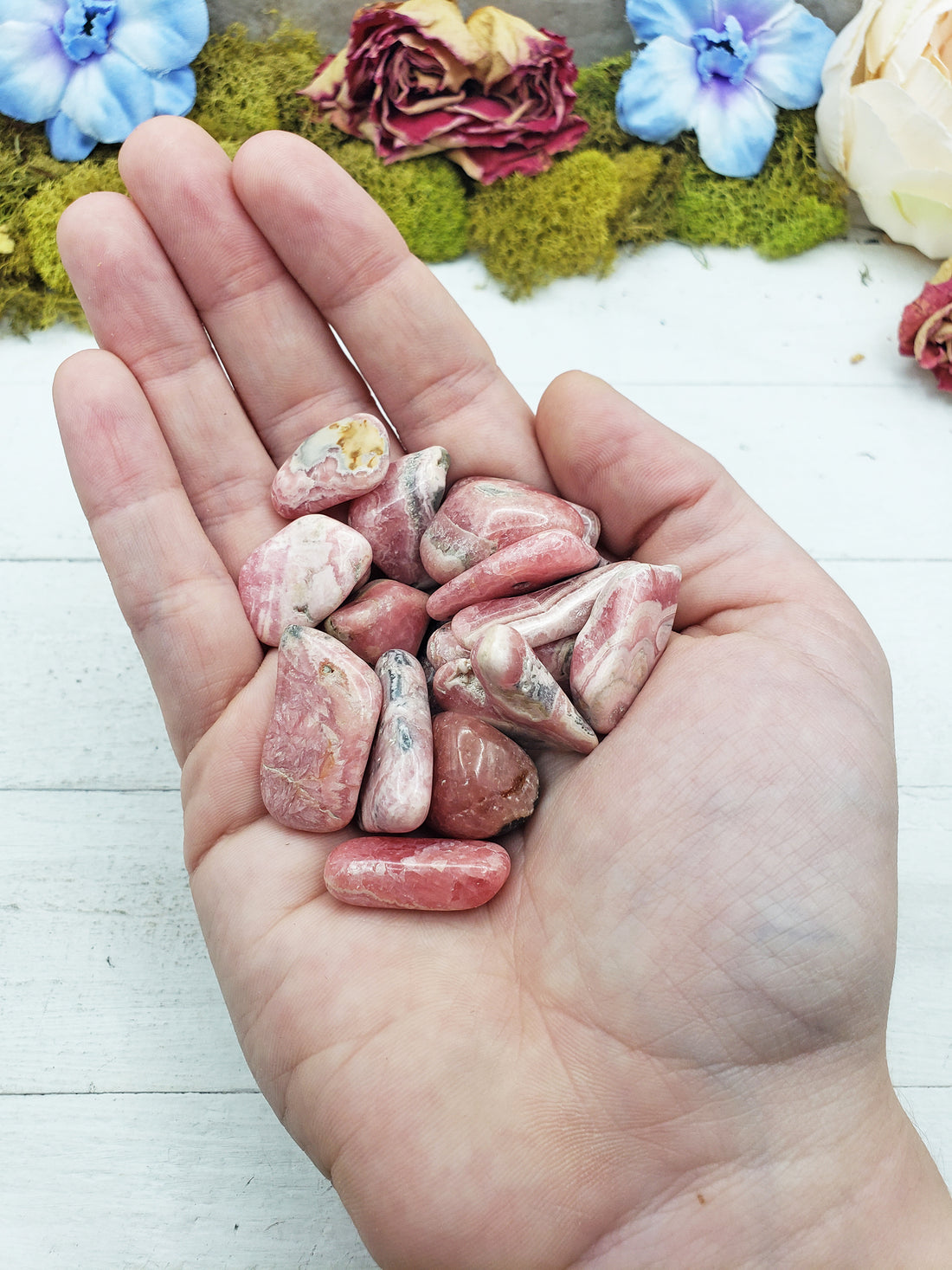 rhodocrosite stones in hand