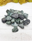 tumbled seraphinite stones on board