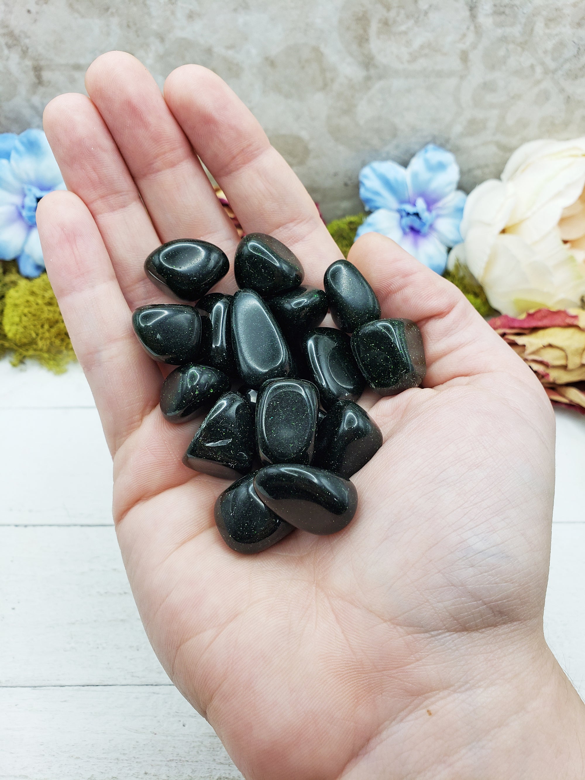 green goldstone crystals in hand