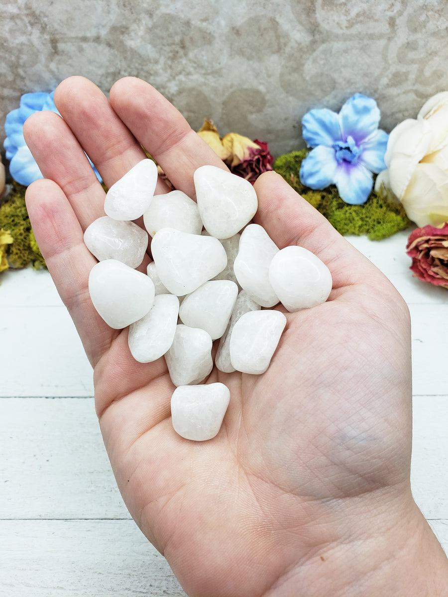 milky quartz stones in hand