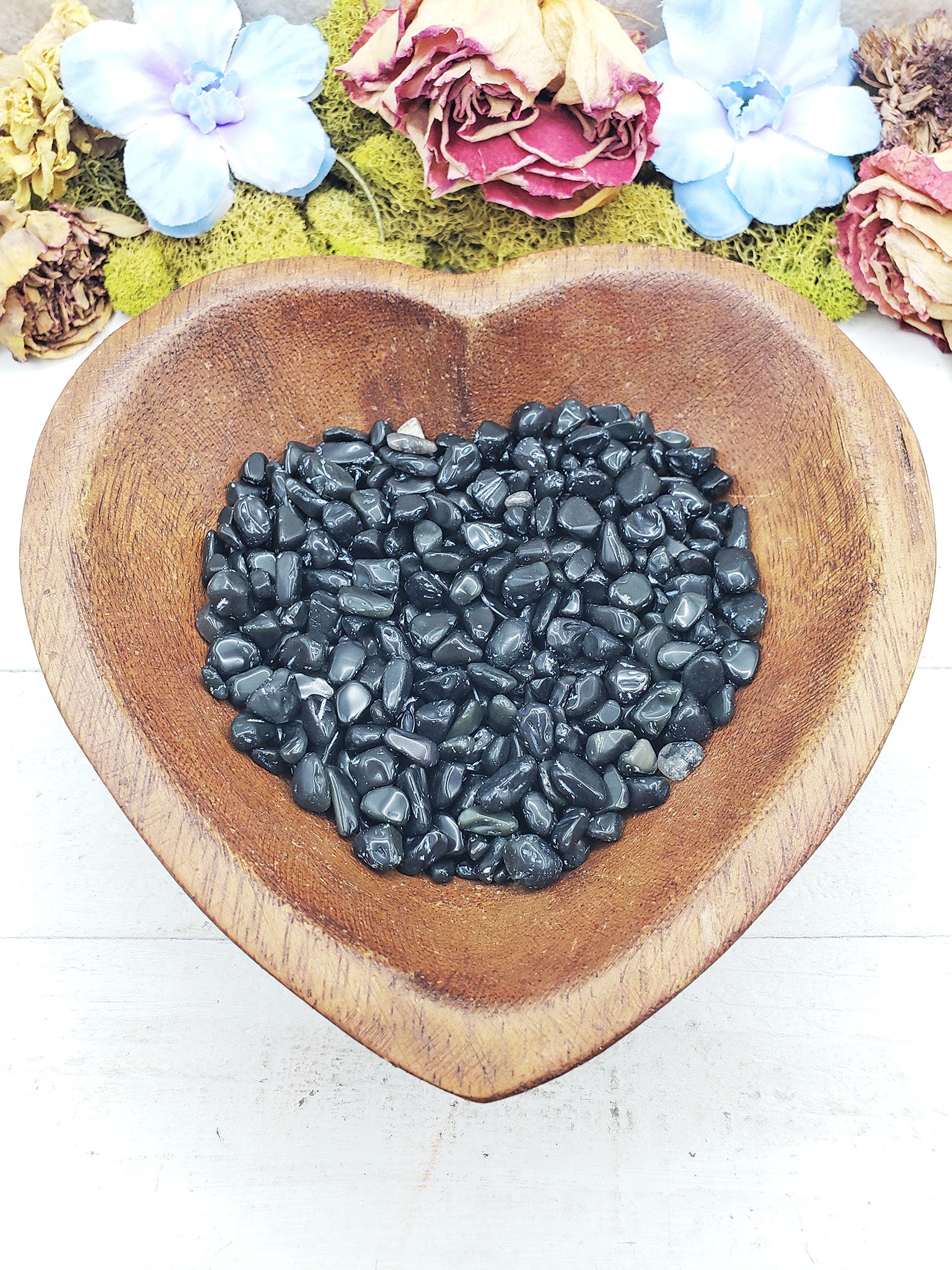 rainbow obsidian crystal chips in wooden bowl