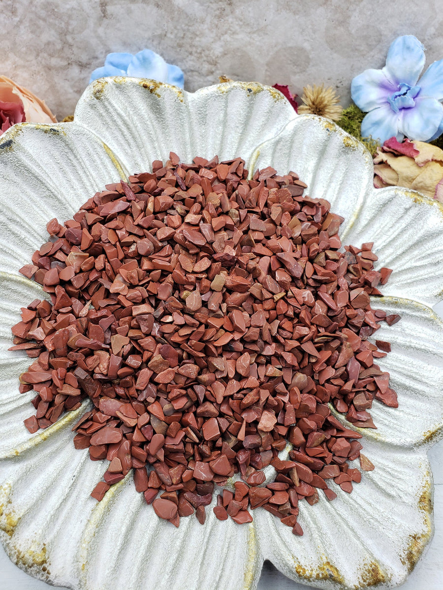 Seven ounces of red jasper stone chips on floral dish display
