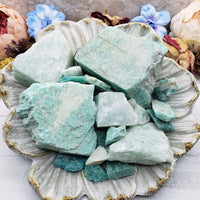 Collection of rough amazonite stones on floral dish