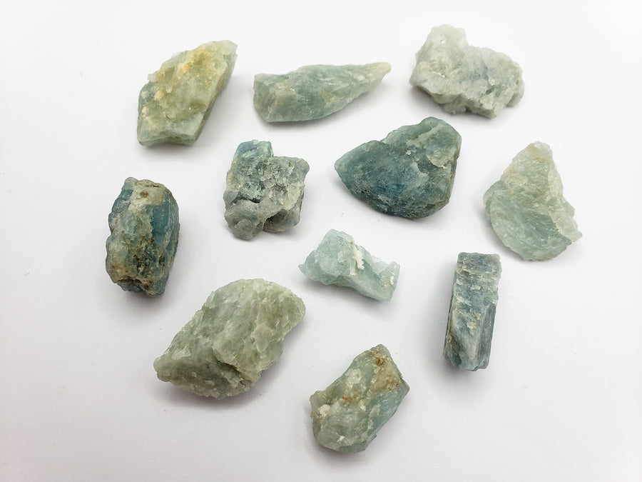 rough aquamarine stones on white background