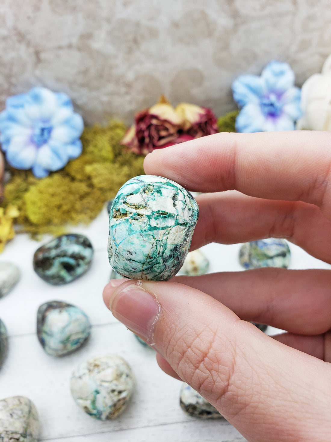 azurite malachite stone between fingers