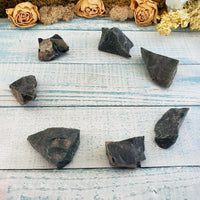 Seven rough bloodstone crystal chunks on display