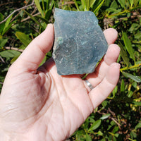 Hand holding rough bloodstone crystal 