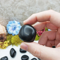 black agate stone between fingers