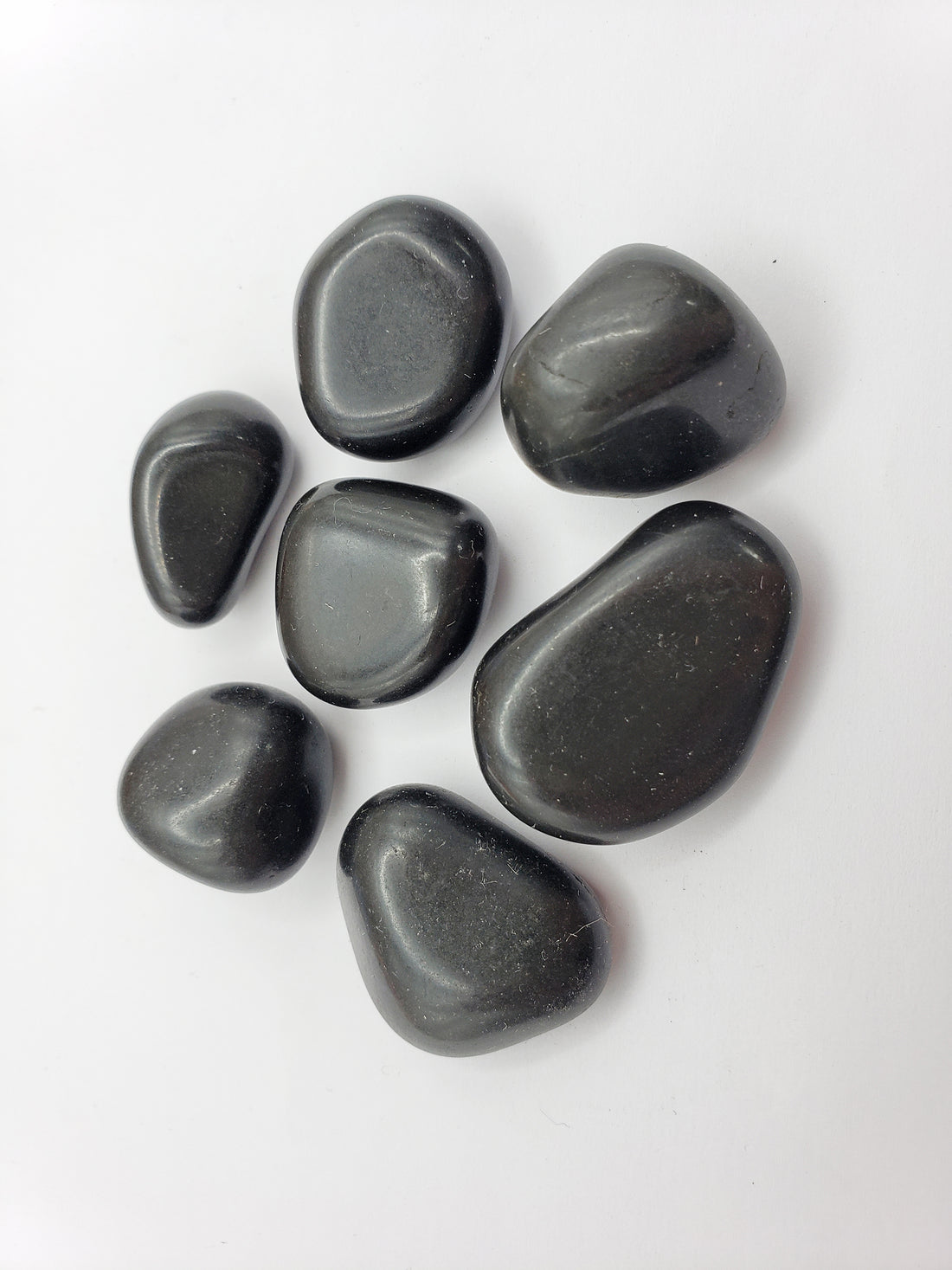 black agate stones on white background