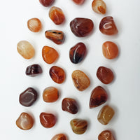mini carnelian stones on white background