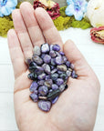 charoite stones in hand