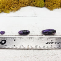 charoite stones by ruler