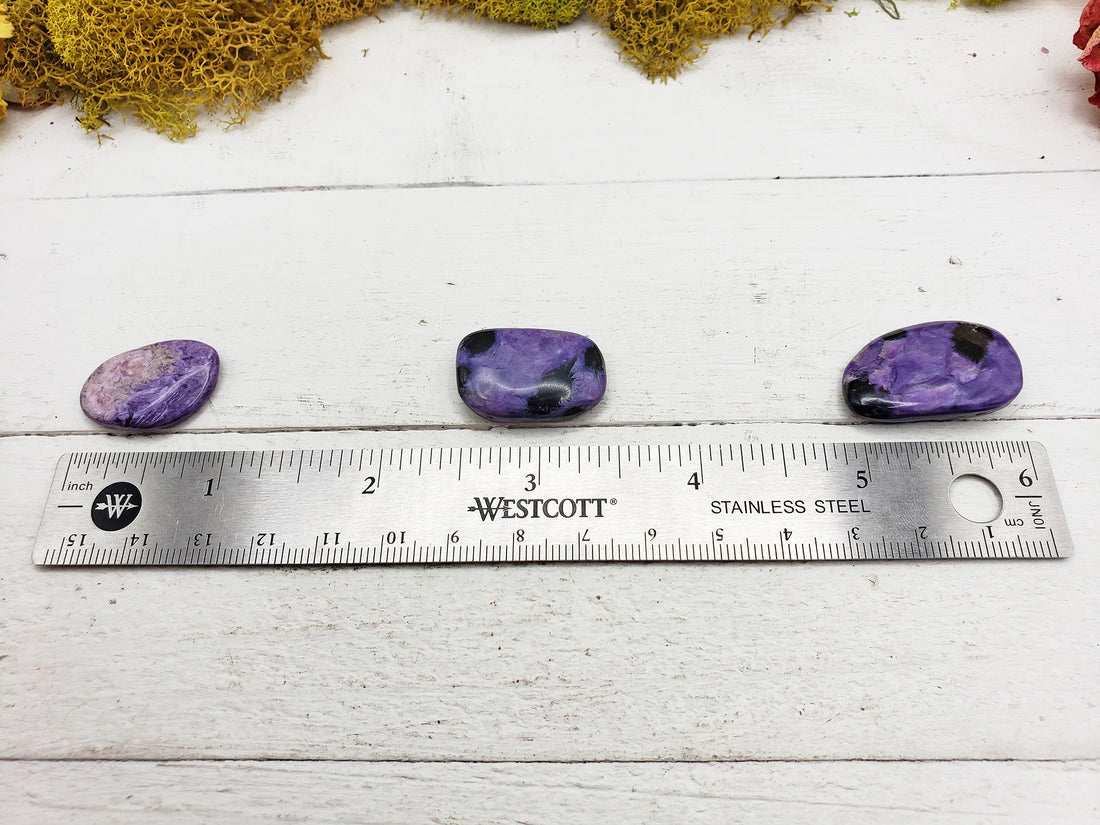 Charoite stones by ruler