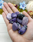 charoite stones in hand