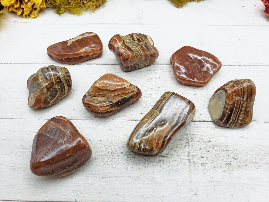 chocolate rhodocrosite stones on board