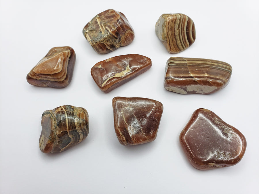 chocolate rhodocrosite stones on white background