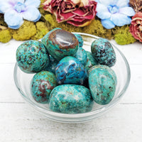 chrysocolla stones in glass bowl