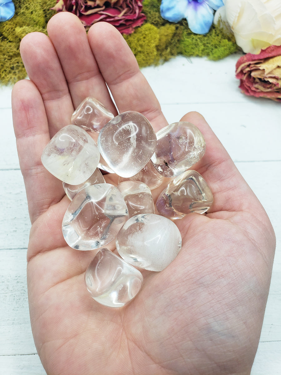 Clear obsidian stones in hand